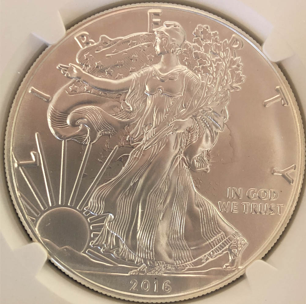 2014 American Silver Eagle showing white spots or milky haze contamination on coin fields known as milk spots
